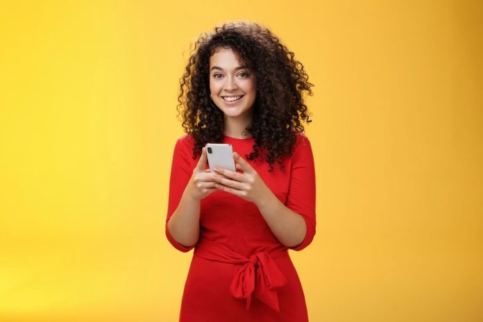 girl smiling while showing how to manage whatsapp