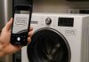 Smart Appliance Identification: How to Locate and Decode Your Model Number Using Technology a-person-holding-phone-next-to-machine