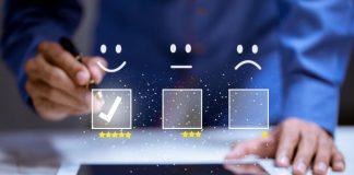 Consumer Satisfaction: The Key to Driving Sales in 2023 man on tablet providing a customer satisfaction review