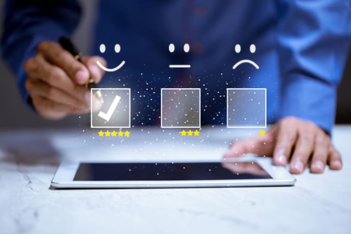 customer-experience-01-2023 man on tablet providing a customer satisfaction review