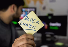 Top 5 Blockchain Technology Trends to Watch in 2026 person holding sticky note