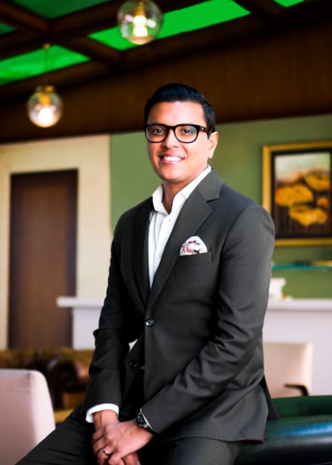 Arpit Agrawal sitting and smiling