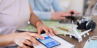 Itilite vs Concur vs Navan vs TravelPerk: The CIO’s Guide to Travel Management Software in 2026 a person using phone