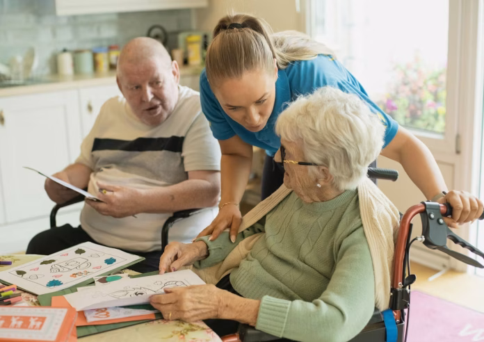 caregiver assisting elderly couple