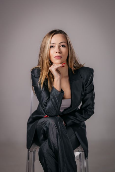 Jana Radojcic leaning forward in a chair