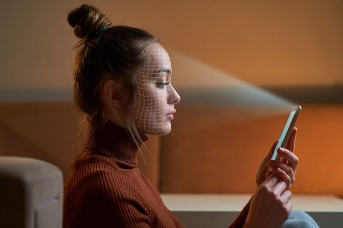 female-scans-face-using-facial-recognition-system-smartphone-biometric-identification-future-digital-high-tech-technology-face-id woman unlocking phone with unlock tools