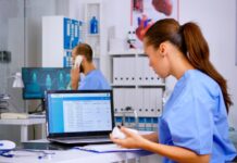 How ASC Software Platforms Help Streamline Daily Surgical Operations Doctor using laptop