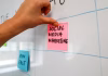 The Biggest Reasons Social Media Ad Campaigns Fail a hand is writing on sticky note