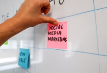 The Biggest Reasons Social Media Ad Campaigns Fail a hand is writing on sticky note