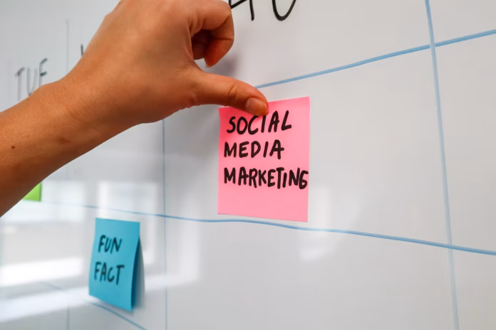 a hand is writing on sticky note