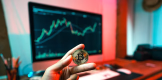 What Is Over-the-Counter (OTC) Trading? How It Works in Modern Cryptocurrency Markets a person holding coin in front of computer