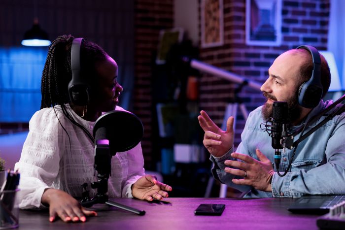 man and woman speaking on ai podcasts