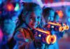 Smart Entertainment Technology is Transforming Family Entertainment girls using entertainment technology to play laser tag