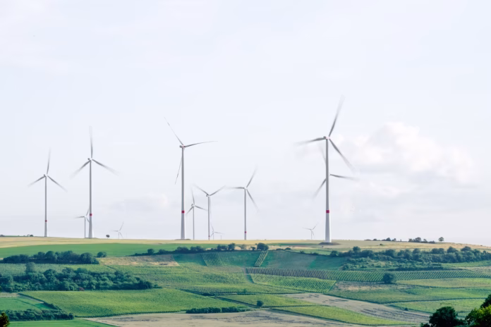windmill surronded by grass during daytime