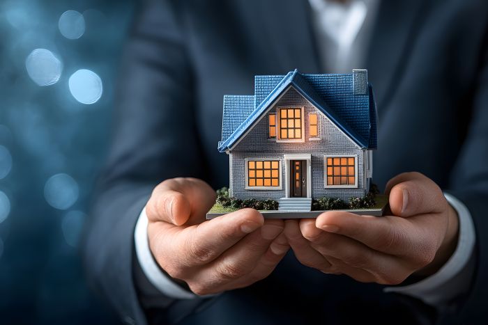 man holding house for property management