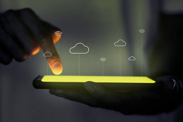 person on ipad using cloud computing