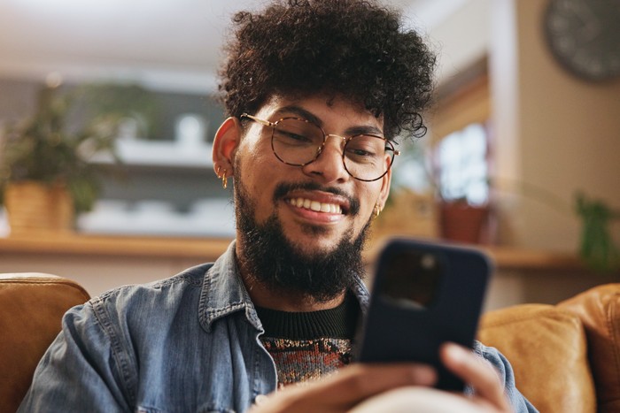 person using phone to play igaming