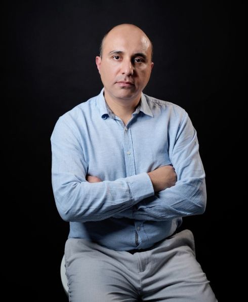Mustafa Alamir sitting with arms crossed