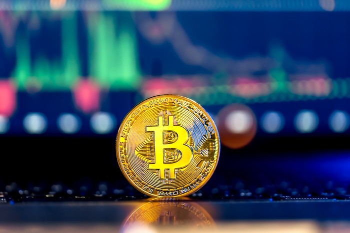 bitcoin glowing in front of keyboard
